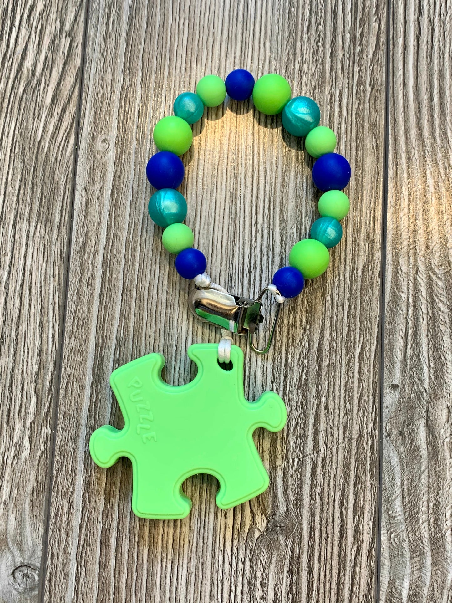 Soother Clip with Green Puzzle Teether